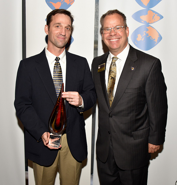 Men posing with an award