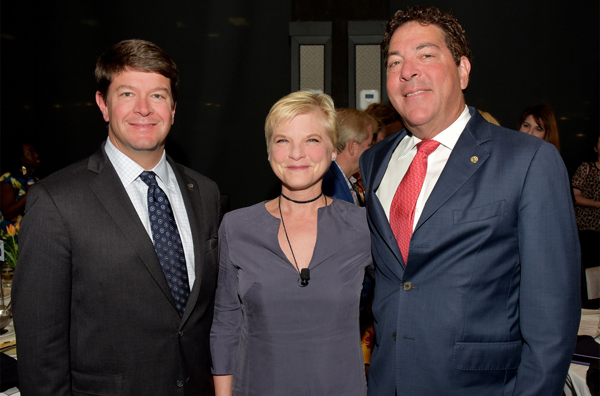 Three people smiling for the camera