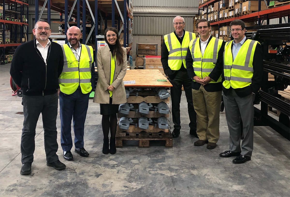 Group photo of personnel in a warehouse